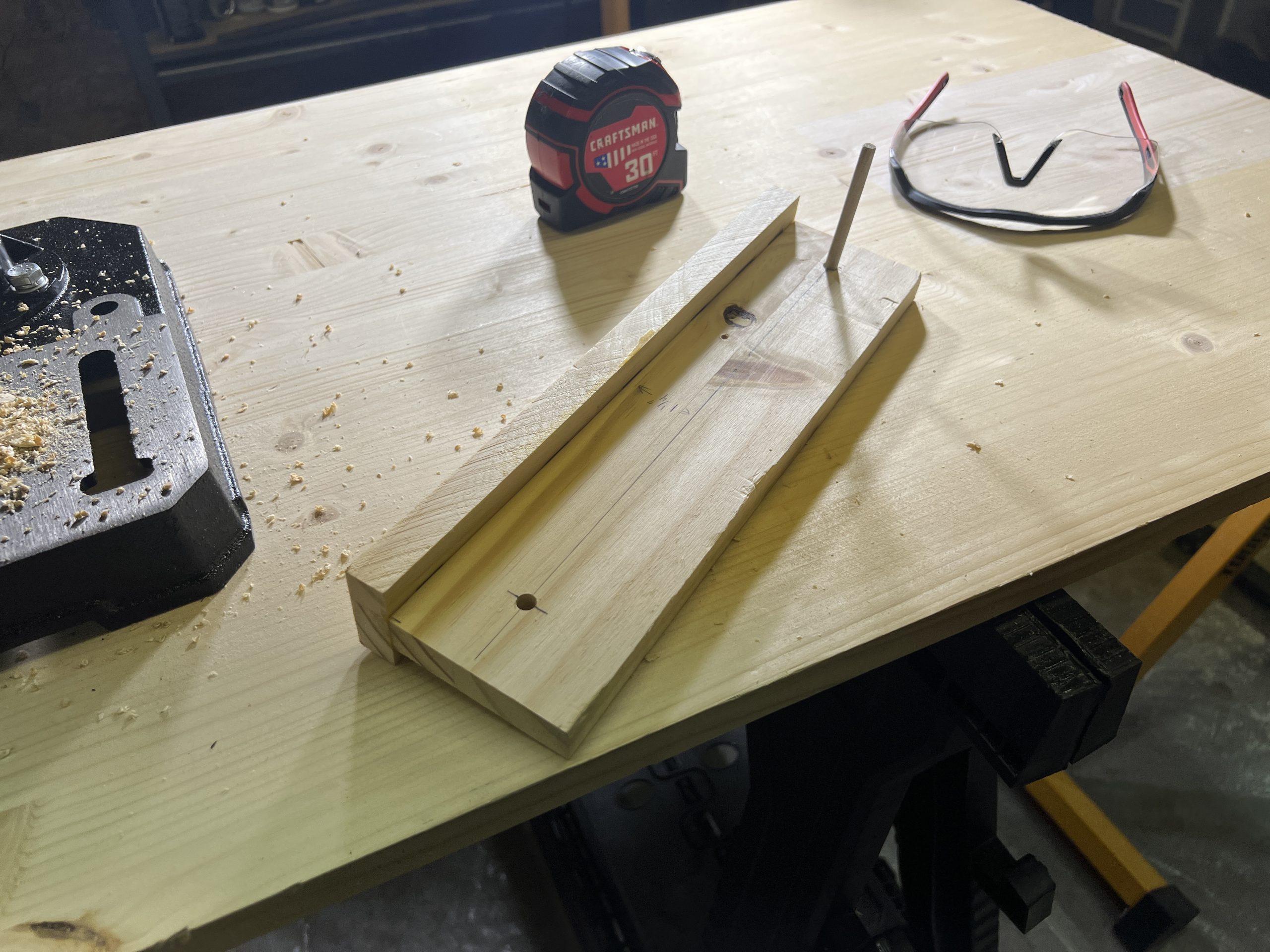 The small jig is made from a 12 inch long board with two holes drilled at the proper spacing.