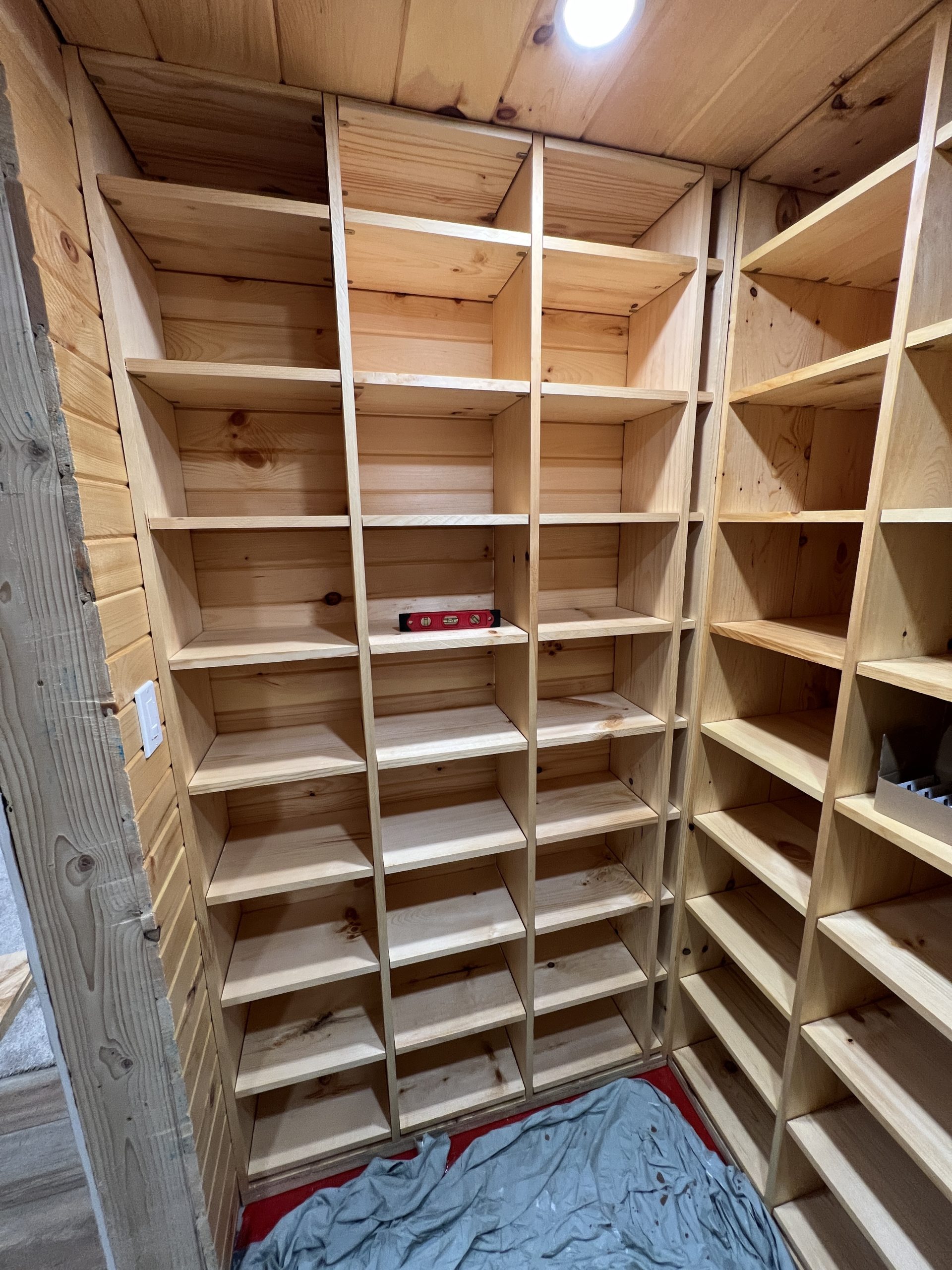 A head on view of the finished wall of wine bins. Each bin measures 13 inches wide by 9 inches tall by 10 inches deep. The wall of bins is three bins wide by 8 bins high.